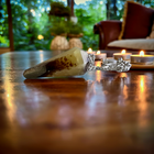 Mookaite jasper pendulum on a wooden floor in a cozy room