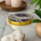 Amethyst charging plate with gold rim on a marble surface